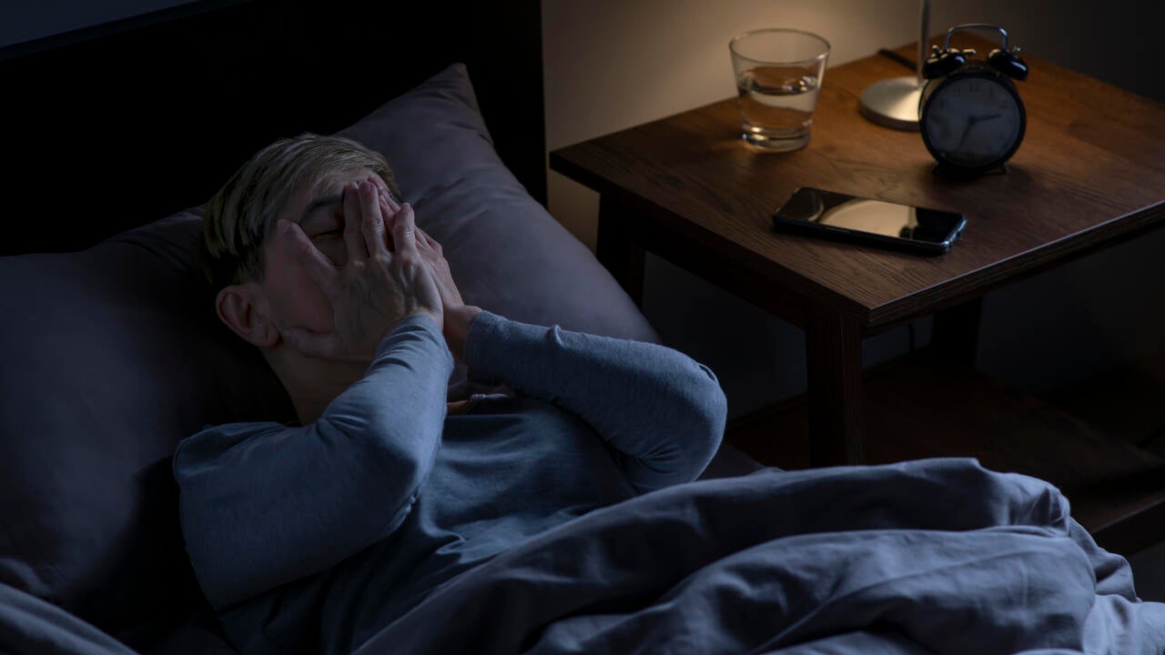 A senior person lying in bed, unable to sleep. (Getty Images/Filmstax) 