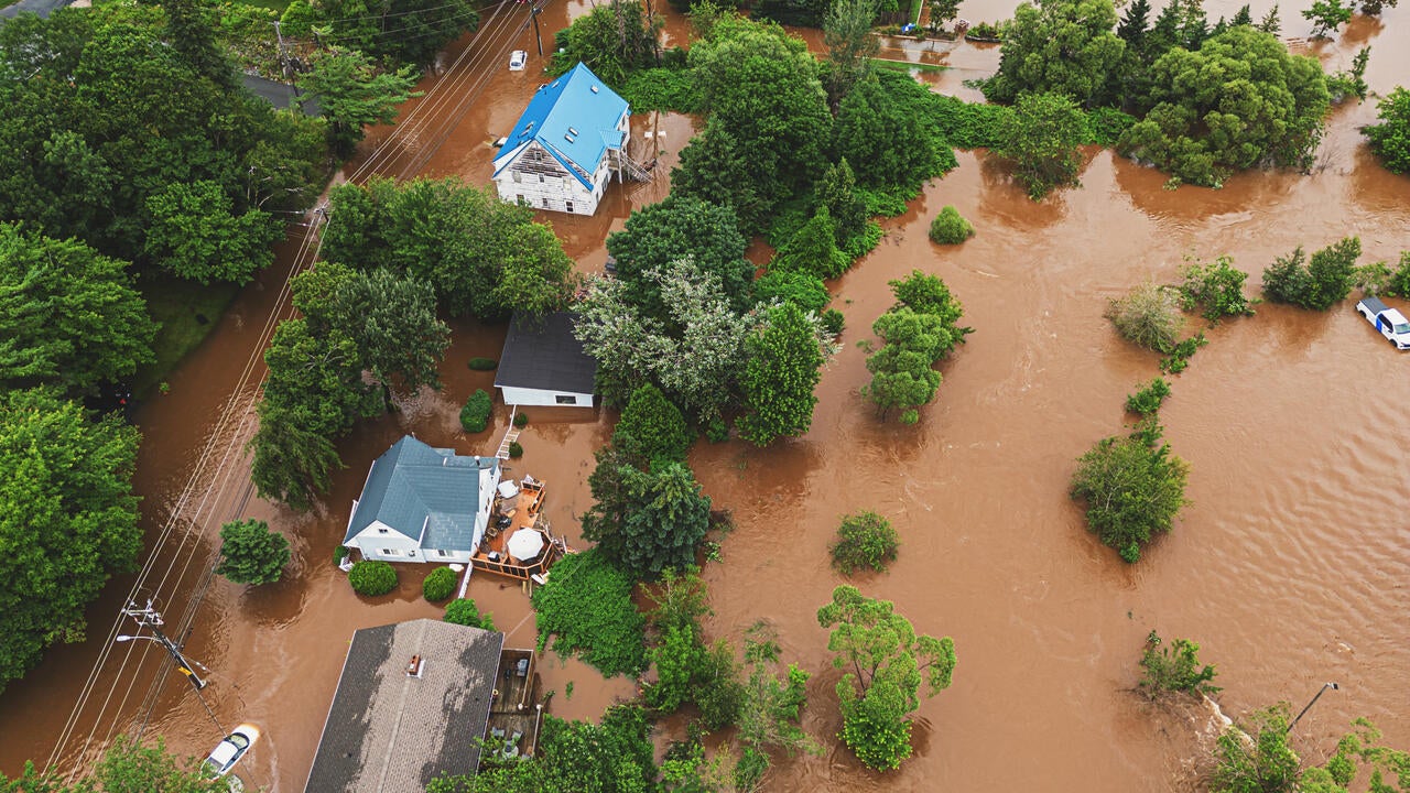 Aerial view of a flooding with houses and trees surrounded by water
