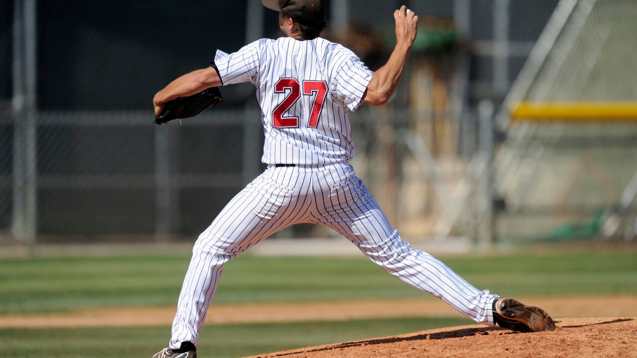 A baseball pitcher throws during a baseball game (Matt Brown/Getty Images). 