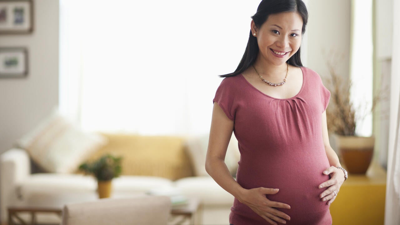 Portrait of smiling Asian expectant mother
