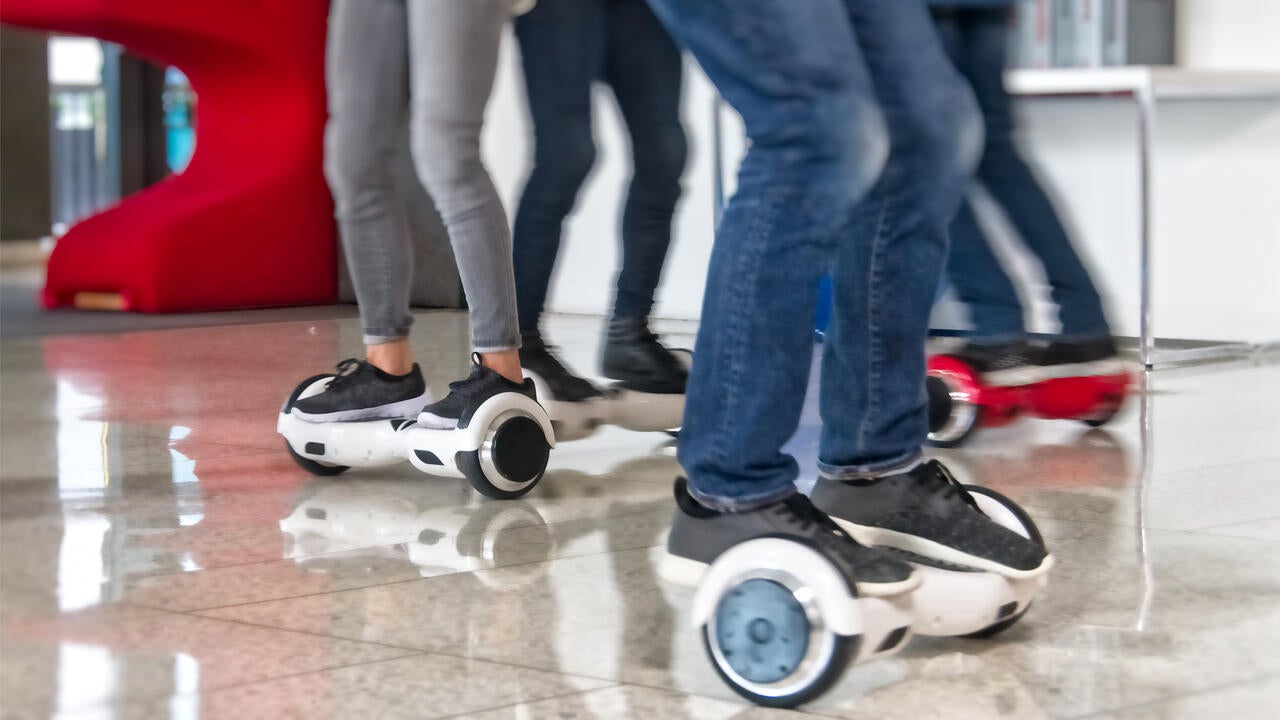 Legs of people riding hoverboards