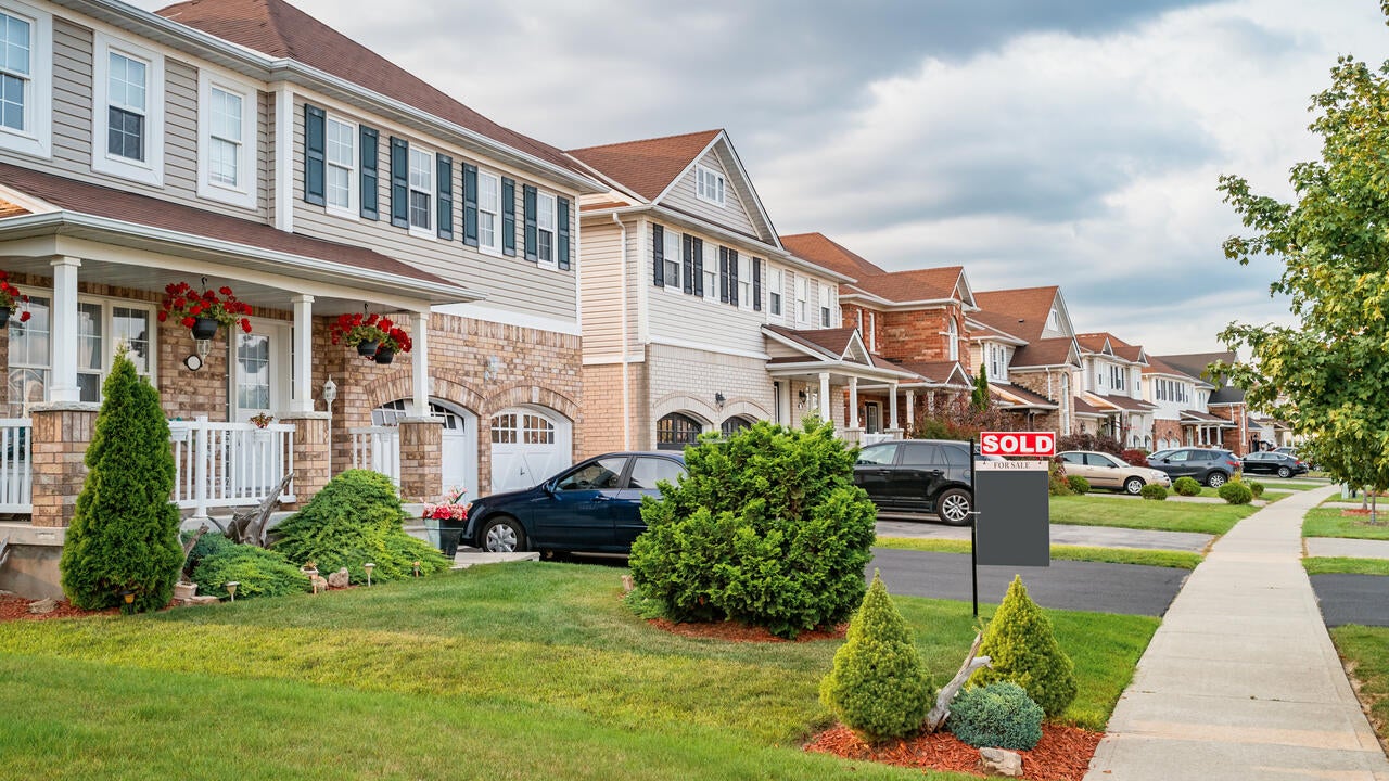  Row of new homes and SOLD sign in Brantford Ontario Canada.