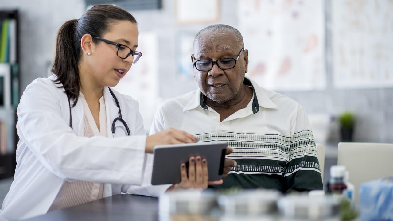 Doctor and patient look at tablet