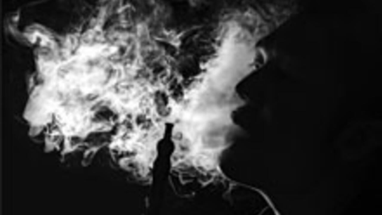 man blowing smoke