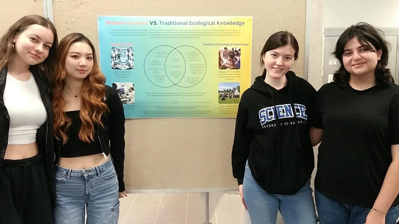 Four students sharing their poster on western science vs. Traditional Ecological Knowledge