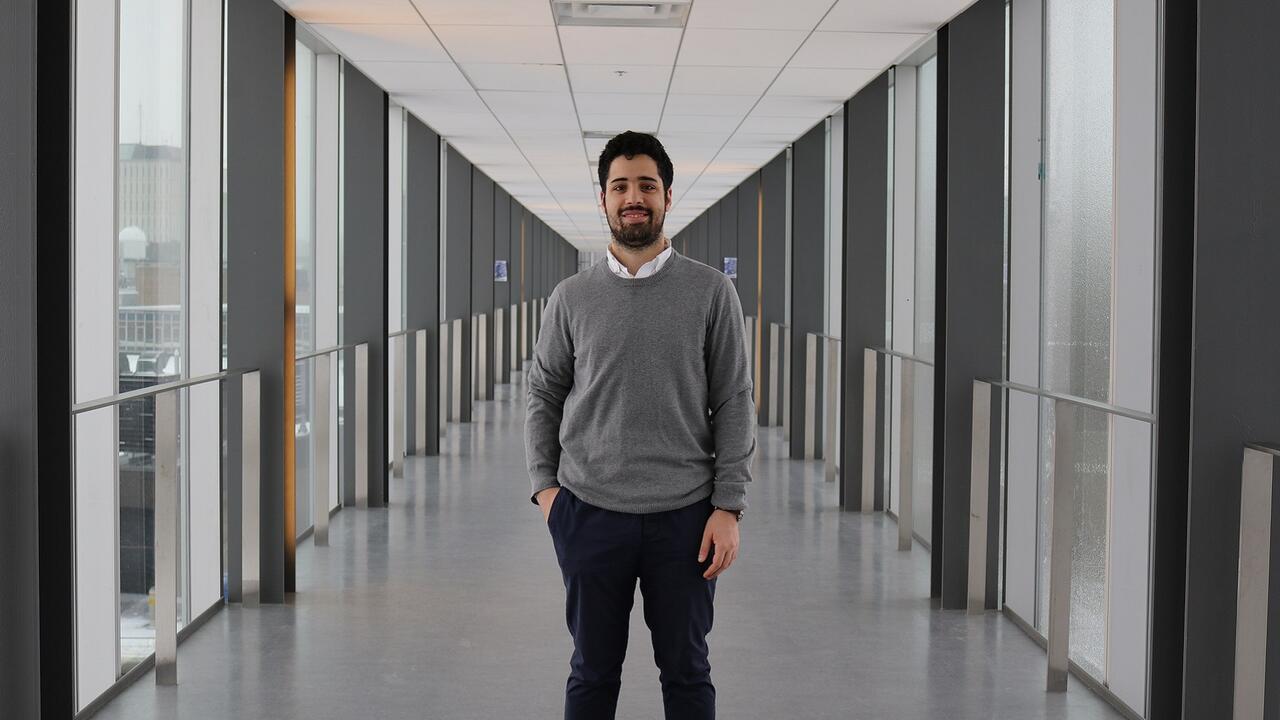 Boy standing in the middle of a hallway 