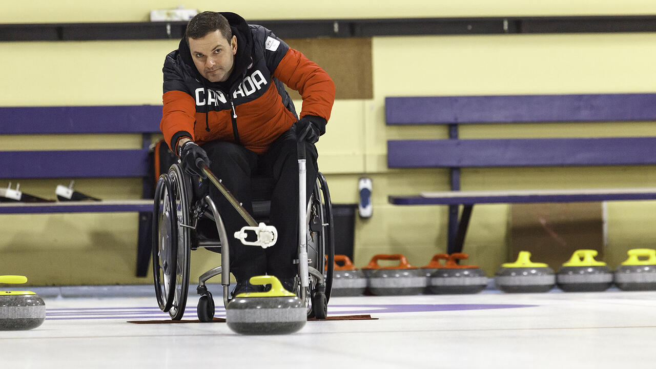 Mark Ideson, skip of the Team Canada wheelchair curling team, takes a shot using the Mark 7 device named in his honour.
