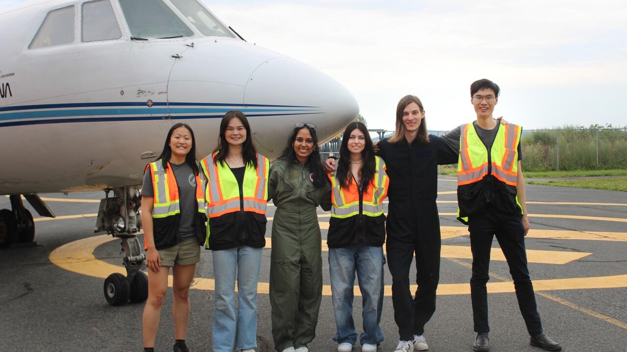 Waterloo Space Soldering Team standing in front of an aircraft