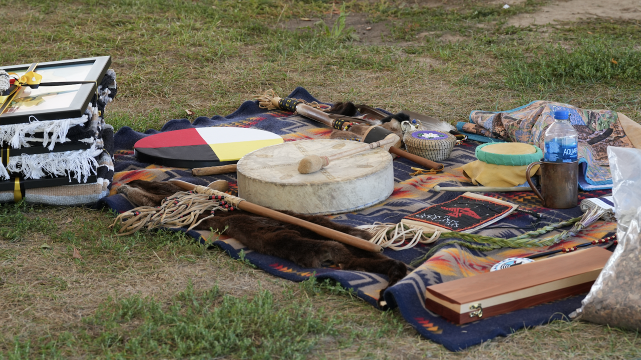 A drug and various Indigenous items on a blanket