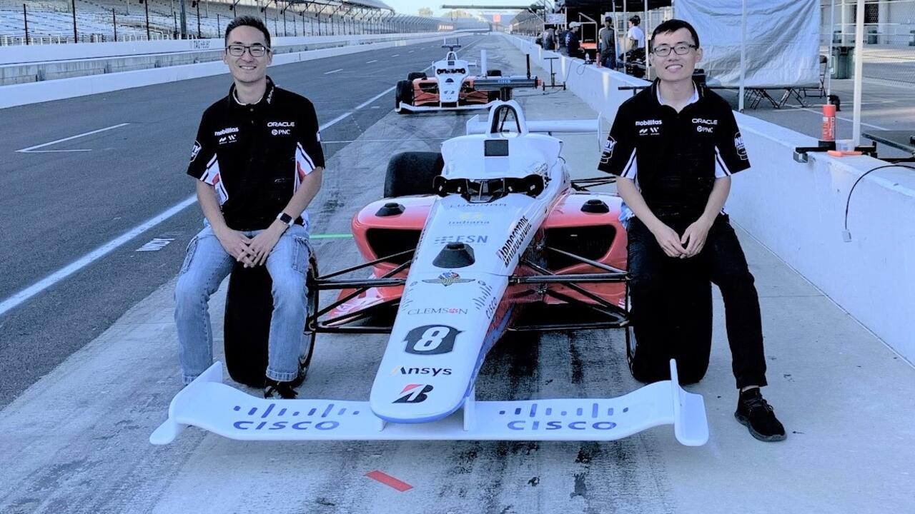 Brian Mao, left, and Ben Zhang with their car at the Indianapolis Motor Speedway.