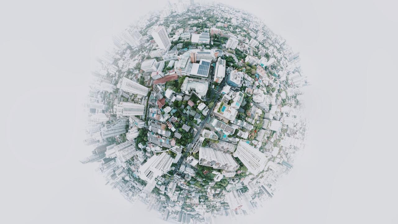 Globe with buildings and trees built on the surface