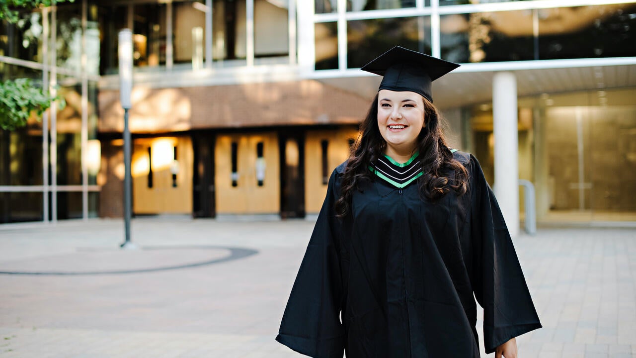 Krenare Rejac in graduation robe and mortarboard 