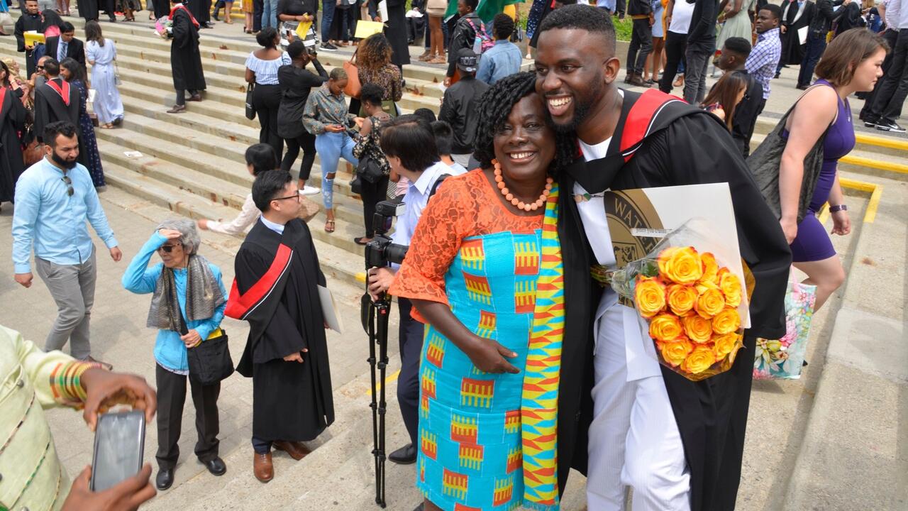 A graduate of Waterloo Engineering poses for photos.