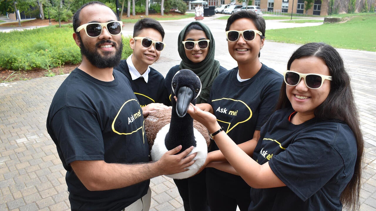 A group of Library ambassadors hold a stuffed Canada goose