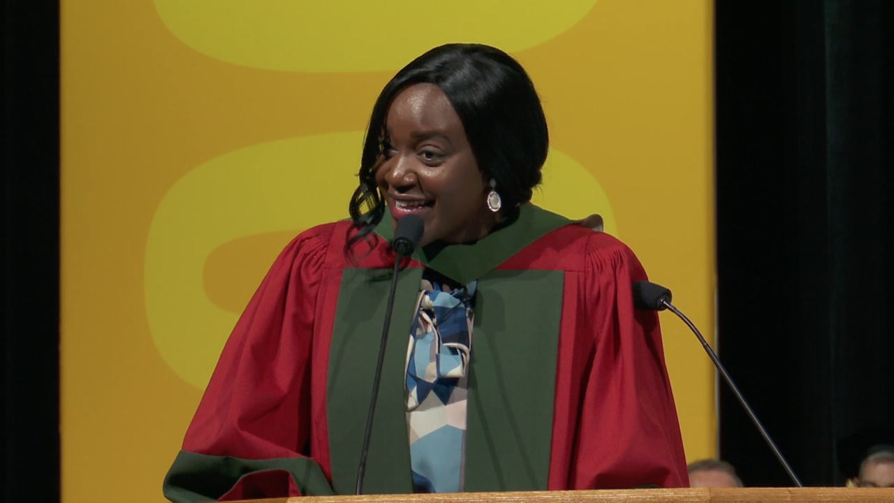 Margaret Mutumba at the podium at convocation