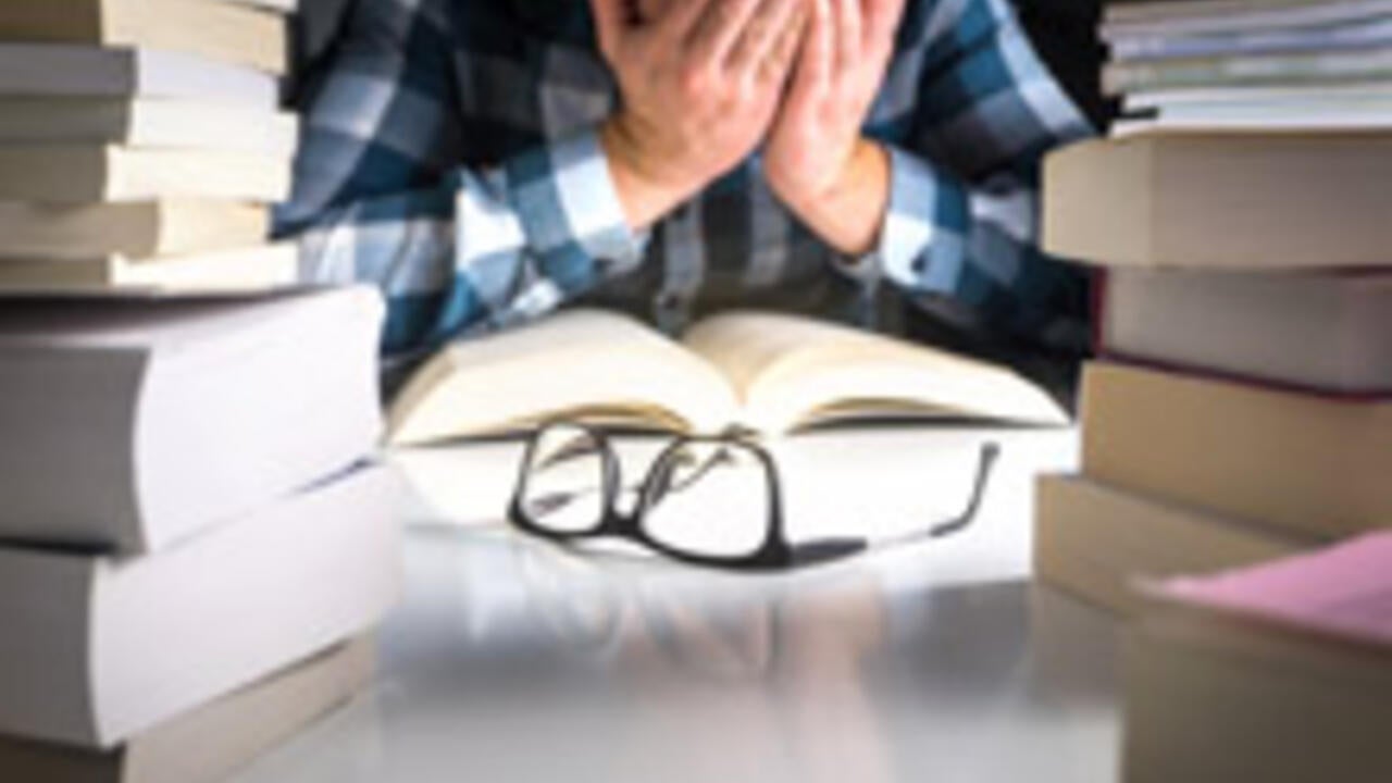 Stressed student with text books