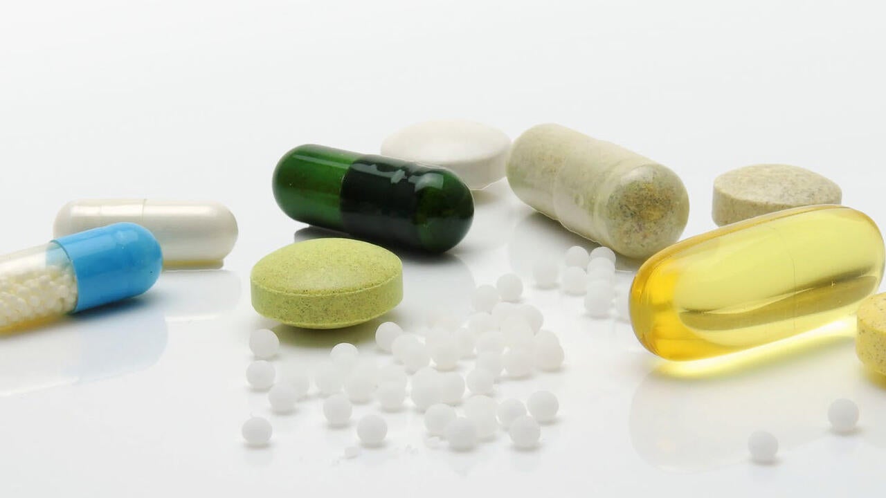 Assorted medical pills on a white surface