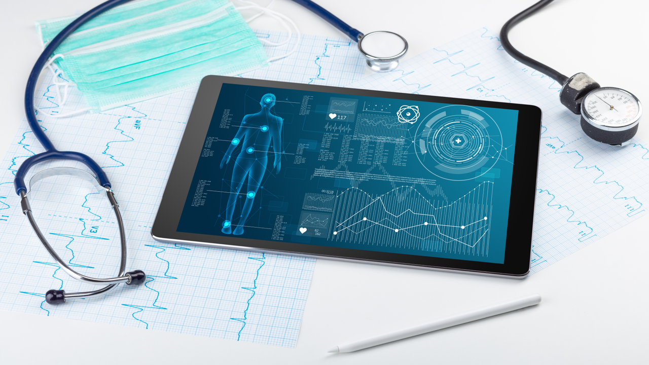 body scanning technology on a laptop surrounded by medical instruments