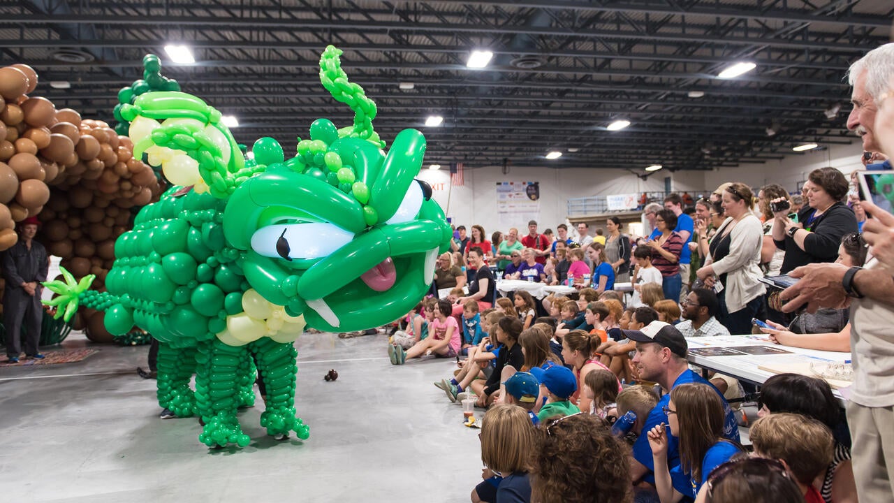 Audience marvels at a life-size balloon dragon