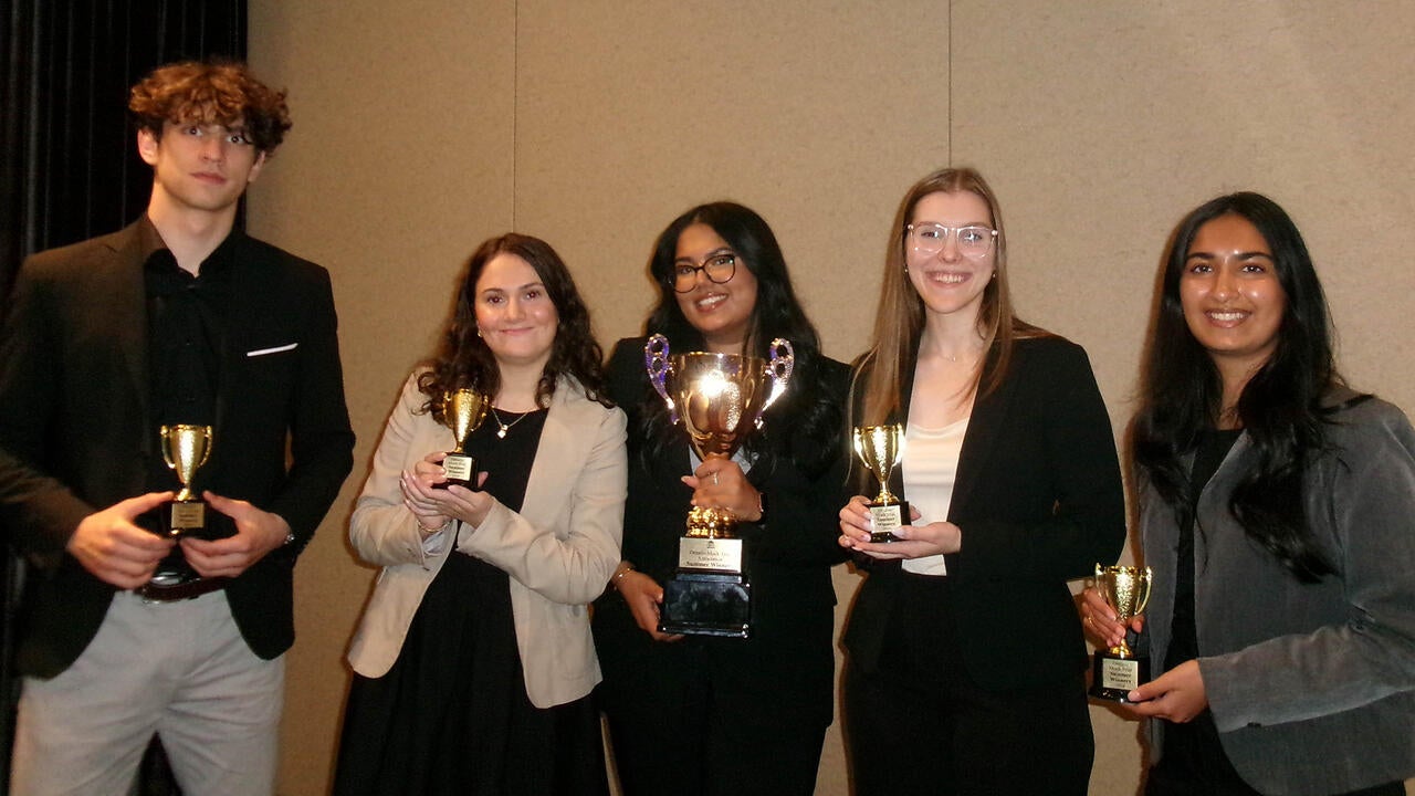 five students holding trophies