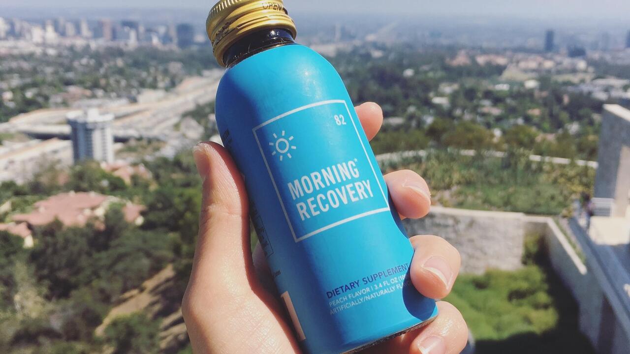 Hand holding a morning recovery bottle