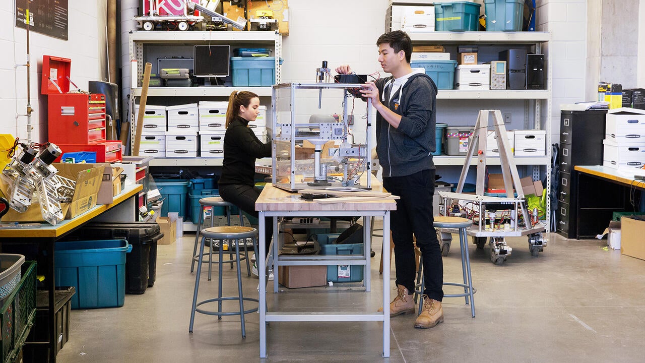 Two students working on robotics
