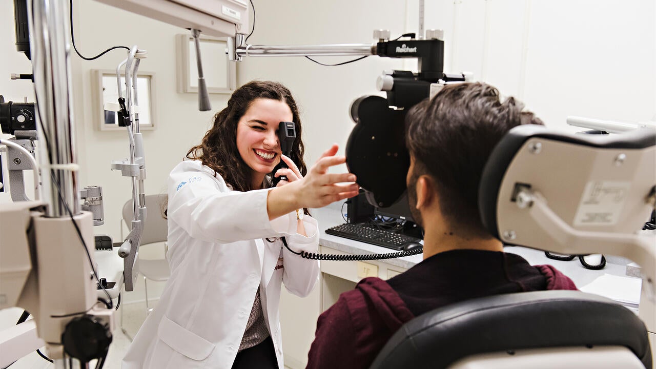 An ophthalmologist working with a patient