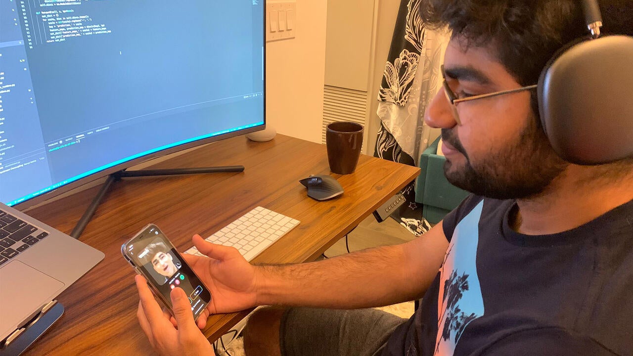 Parshant Utam looking at the Wombo app on his phone