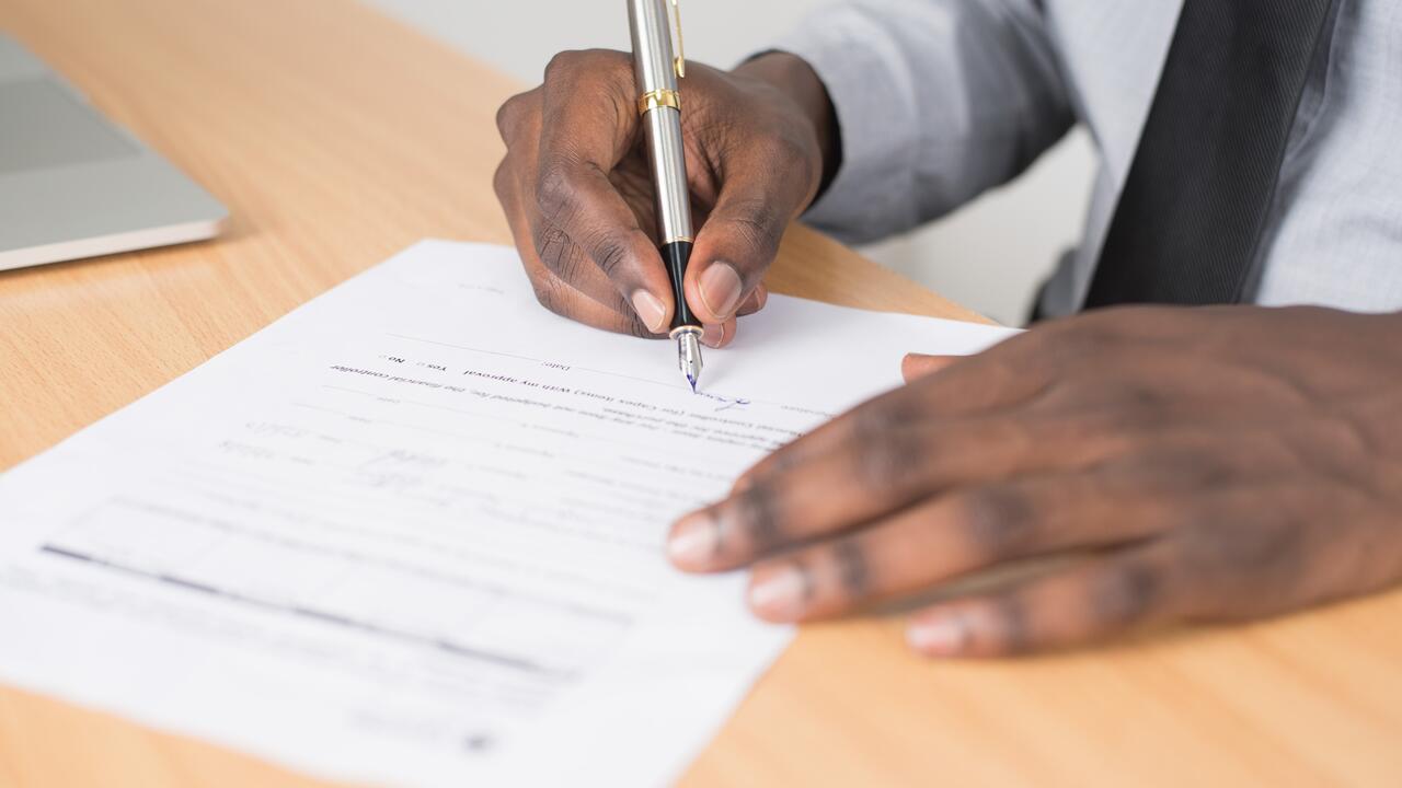 Top-down view of paperwork being signed