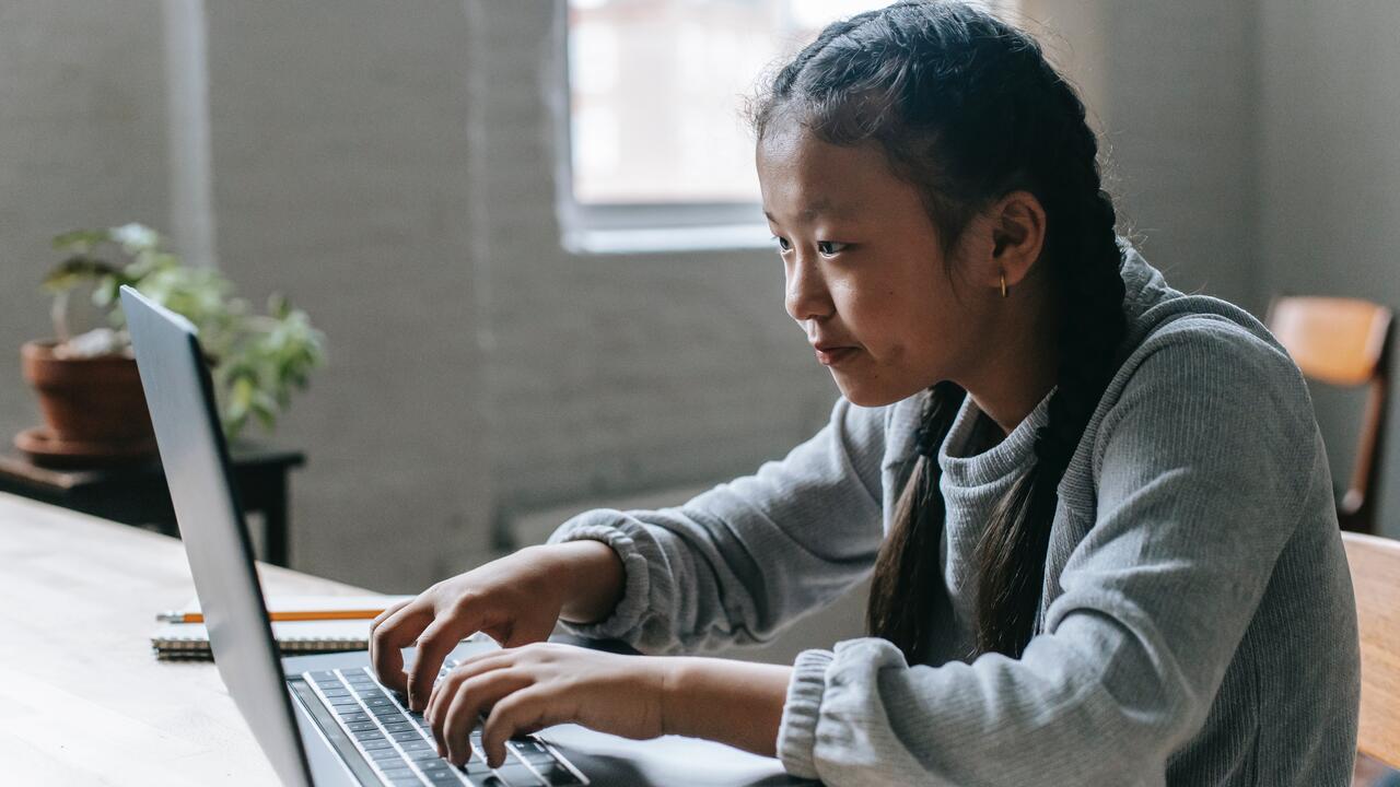 A girl works on a computer.