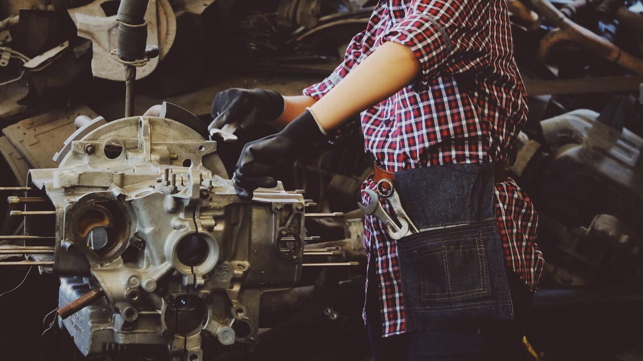 Person working on car engine