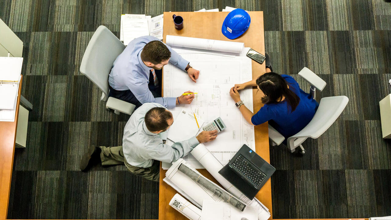 Engineers working at a desk overshot