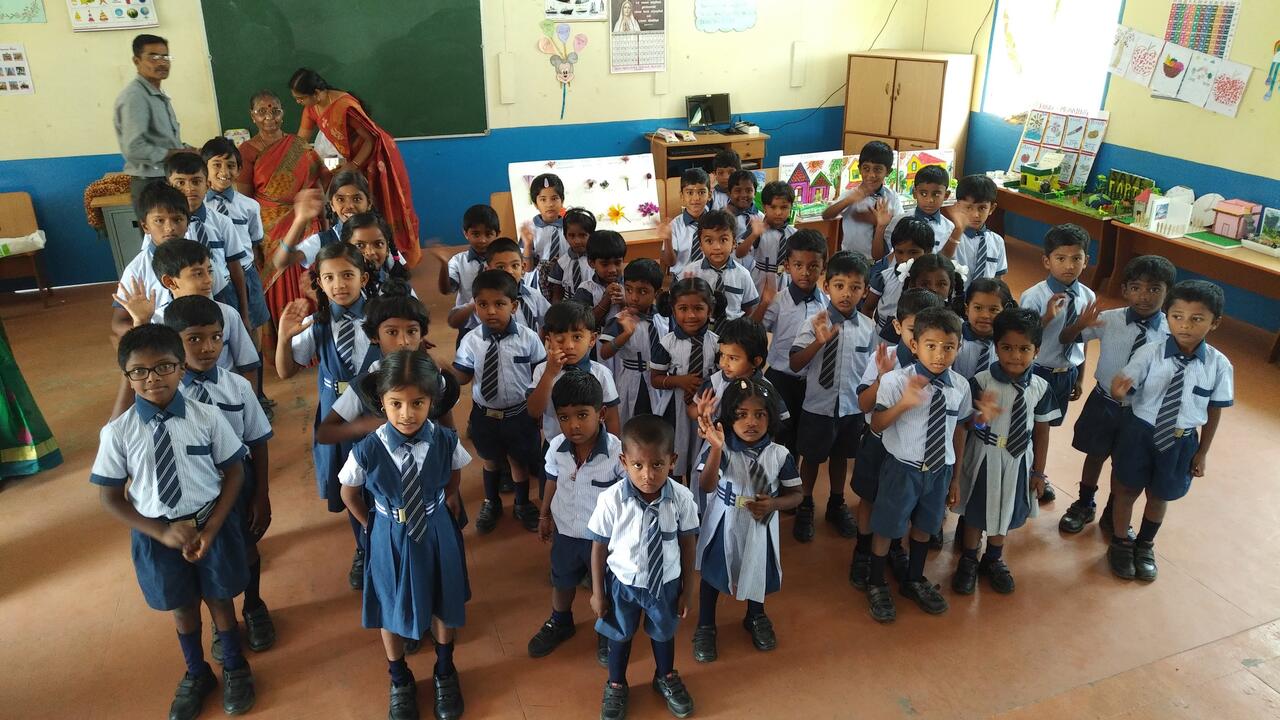 Michael Steele and Stacey Coote celebrate the construction of a school in rural India along with community members 