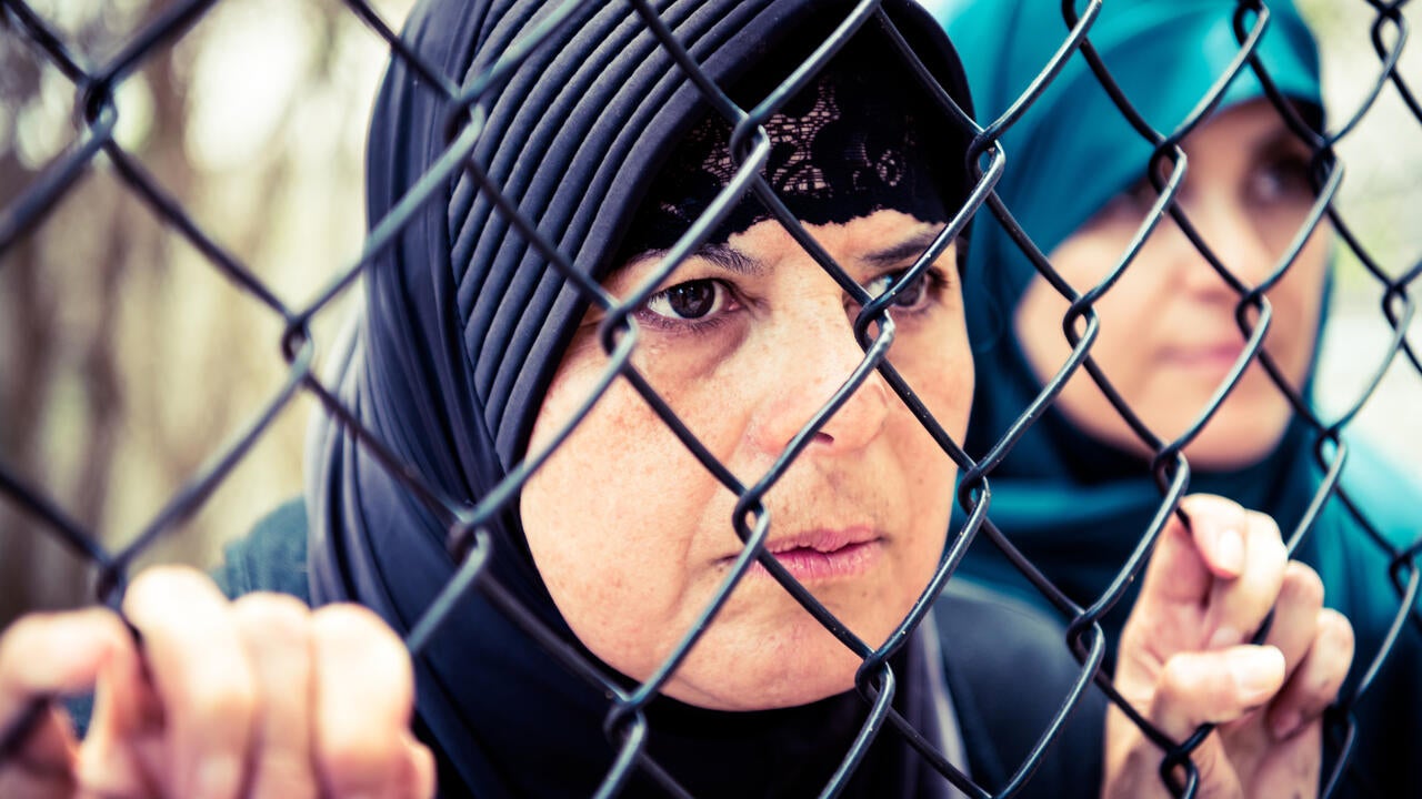 Lady behind a fence 