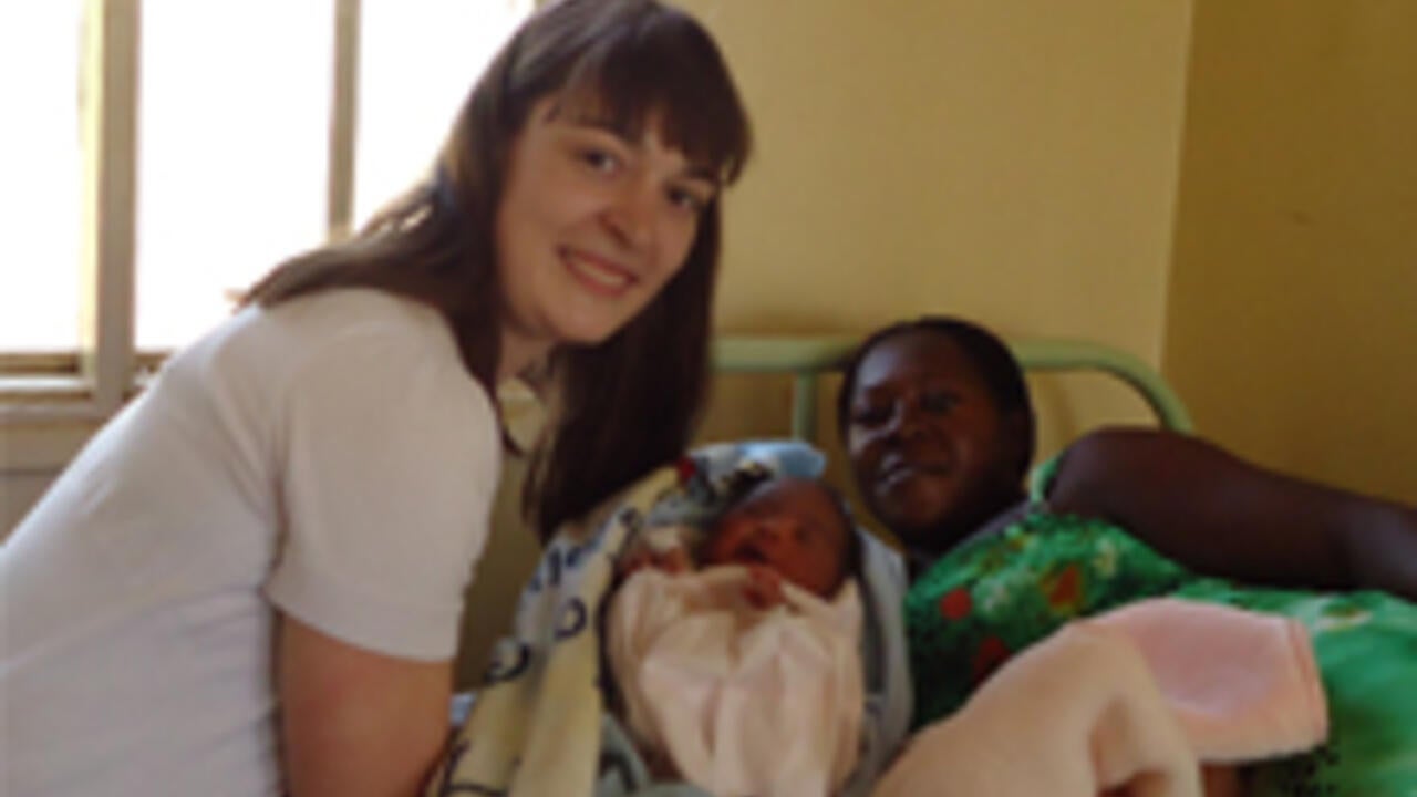 Christina Marchand with a mother and baby in Uganda