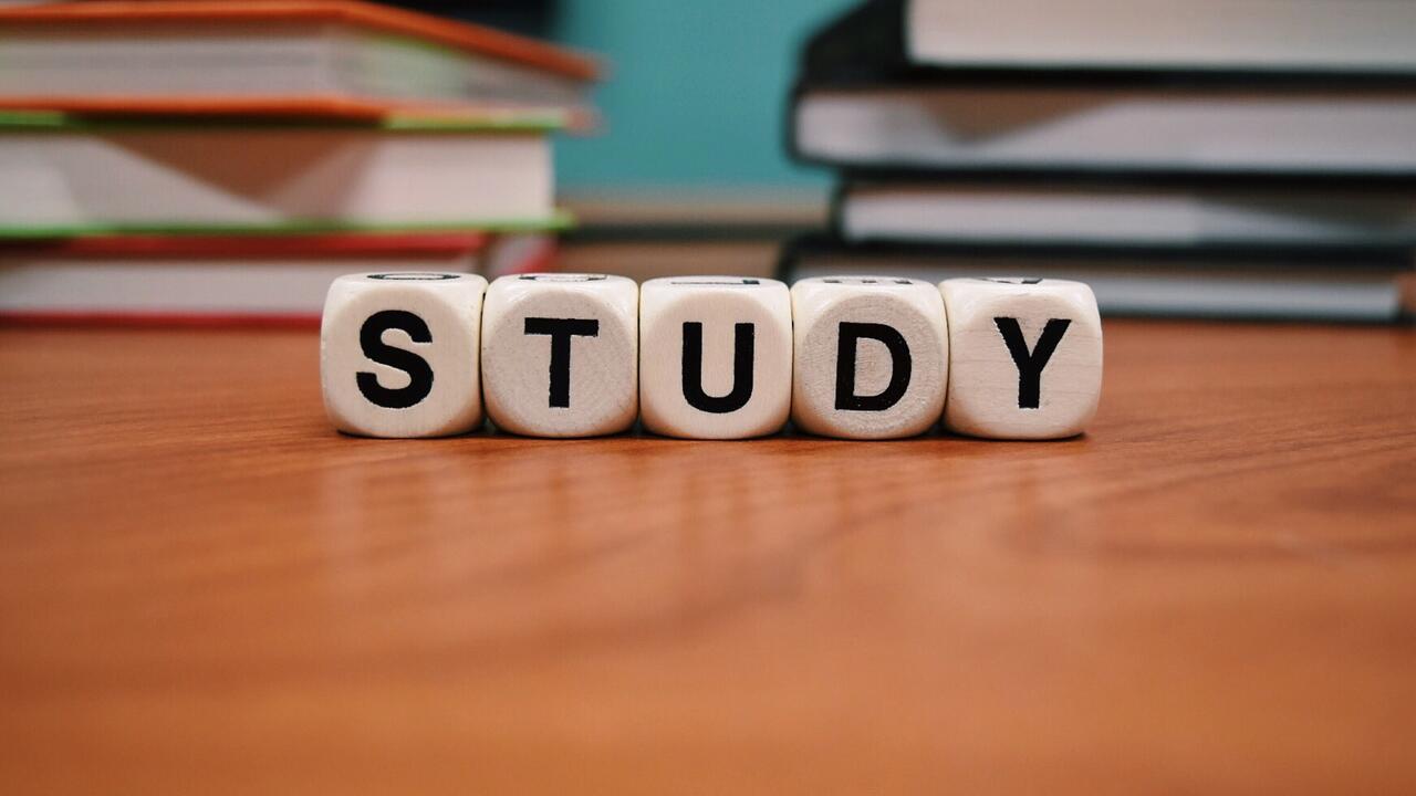 The word 'study' spelled out in front of books.