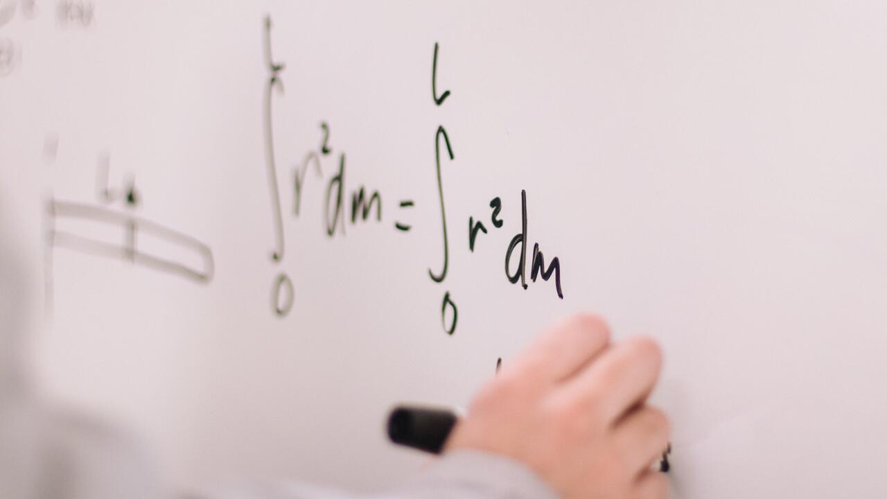 Hand writing on a whiteboard