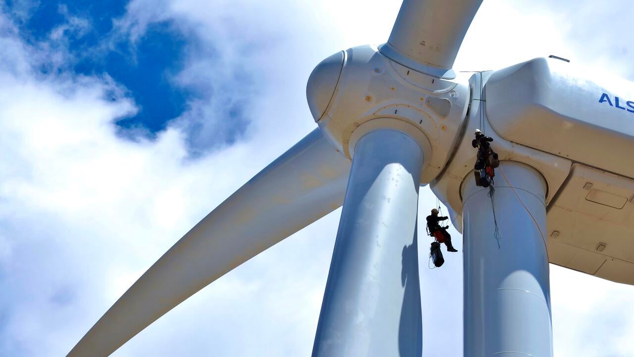 wind turbine with two workers on rigging