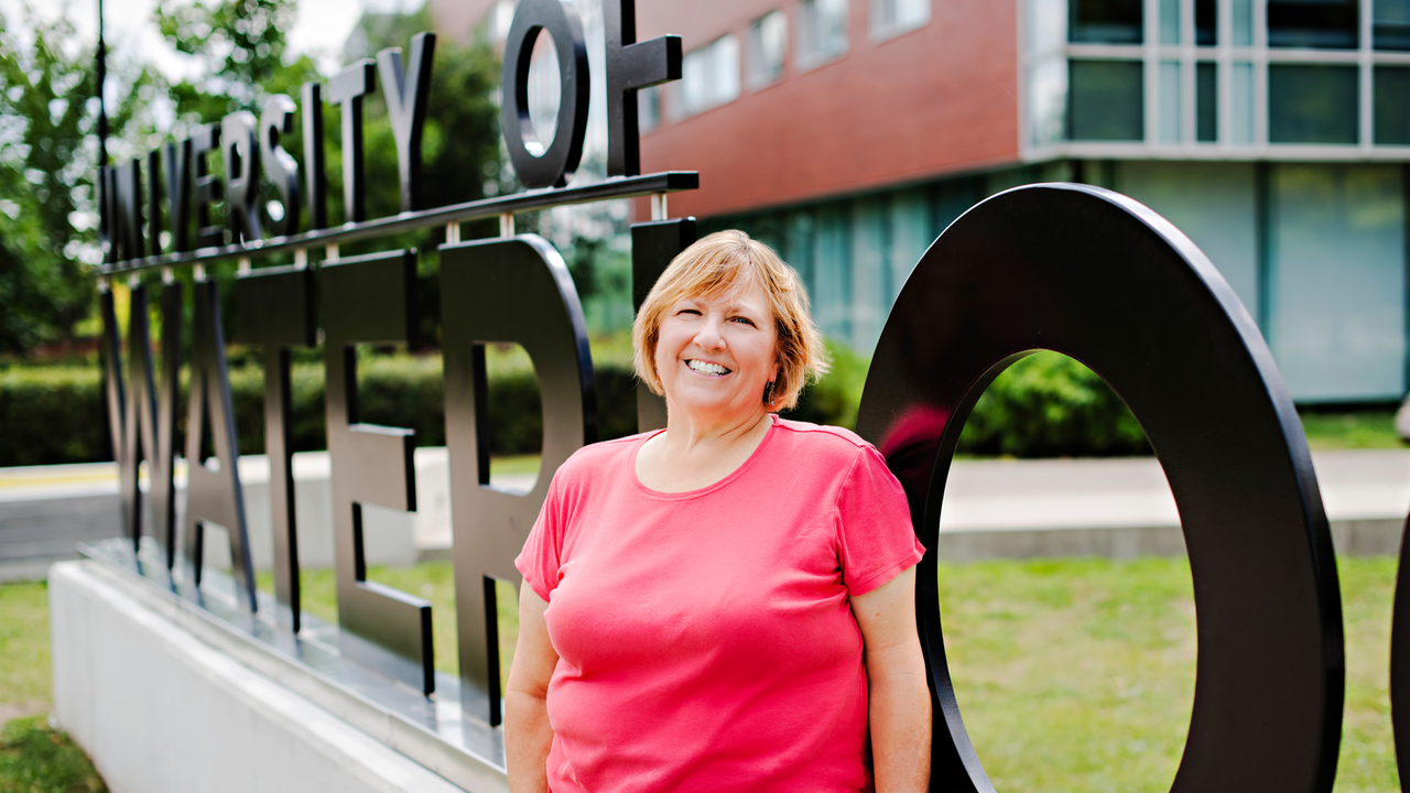 Sharon Lamont stands in front of University of Waterloo sign