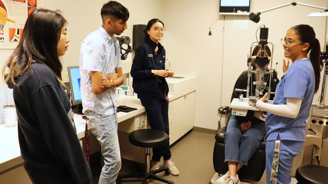 Students conducting a slit lamp demonstration