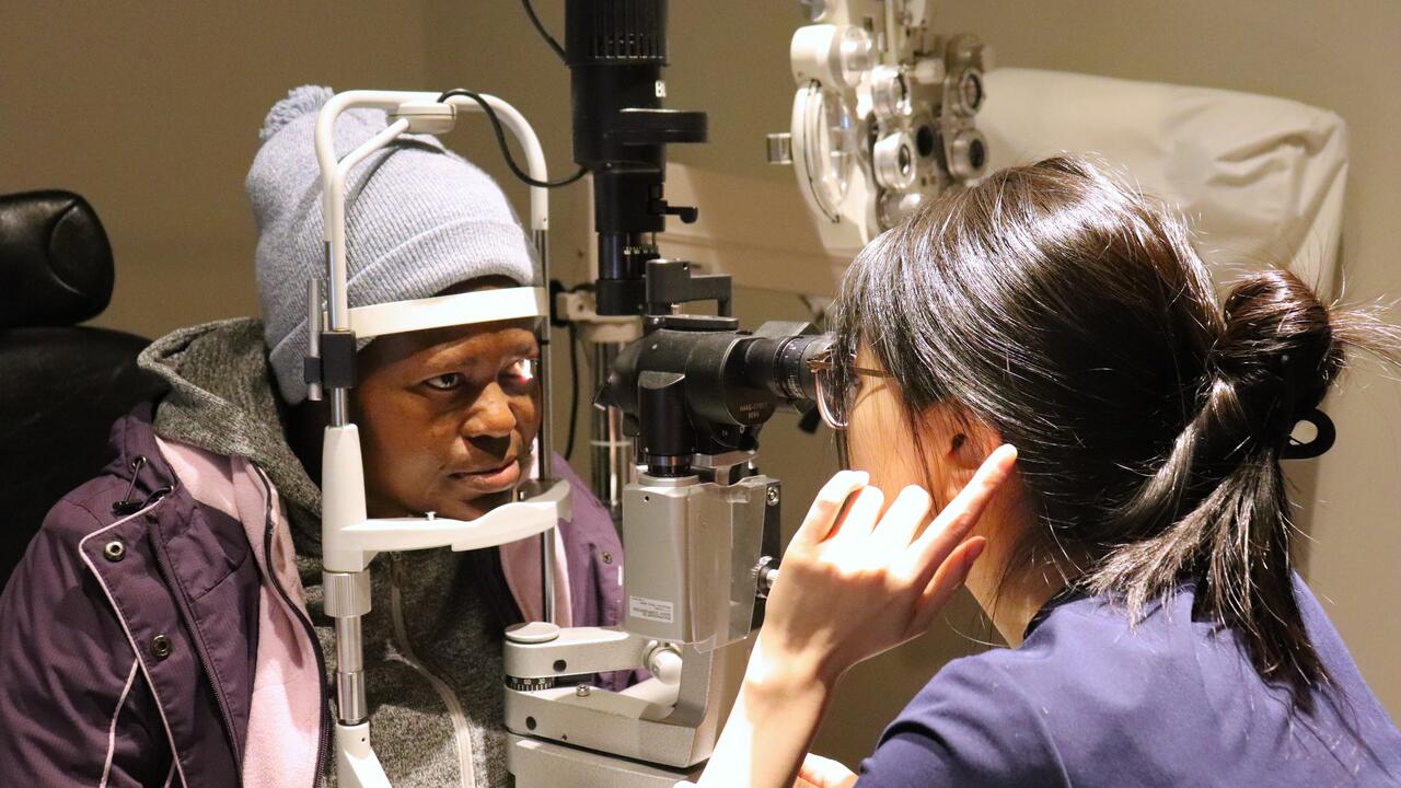 Person looking a slit lamp during eye exam
