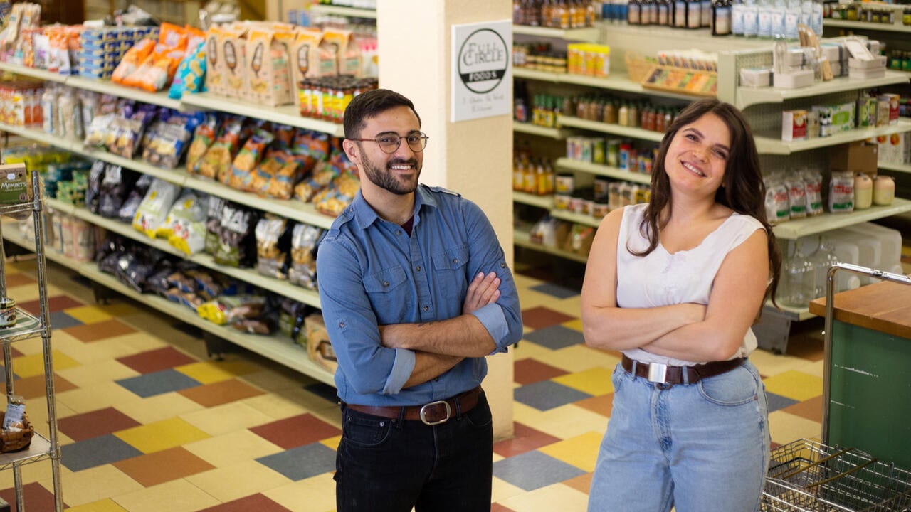 Two Waterloo alumni standing in the middle of a grocery store