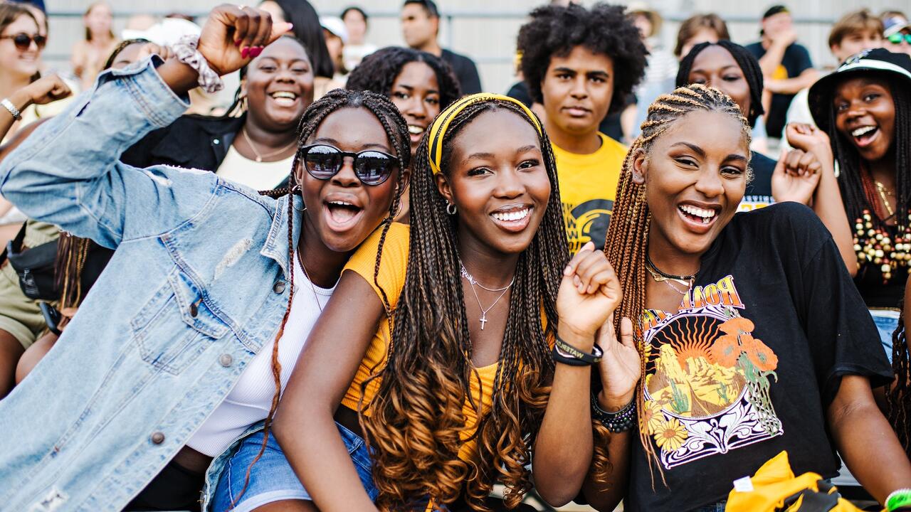 Black students cheer and smile in UWaterloo gear