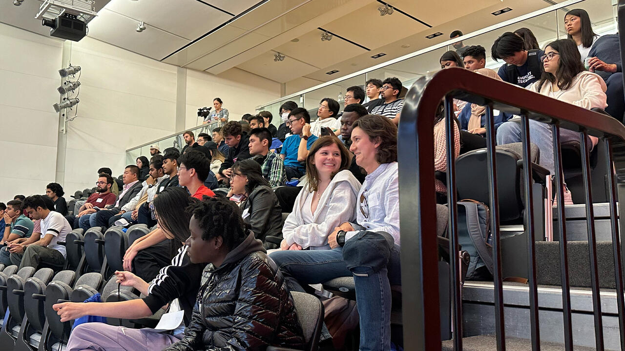Students sitting in auditorium watching presentation
