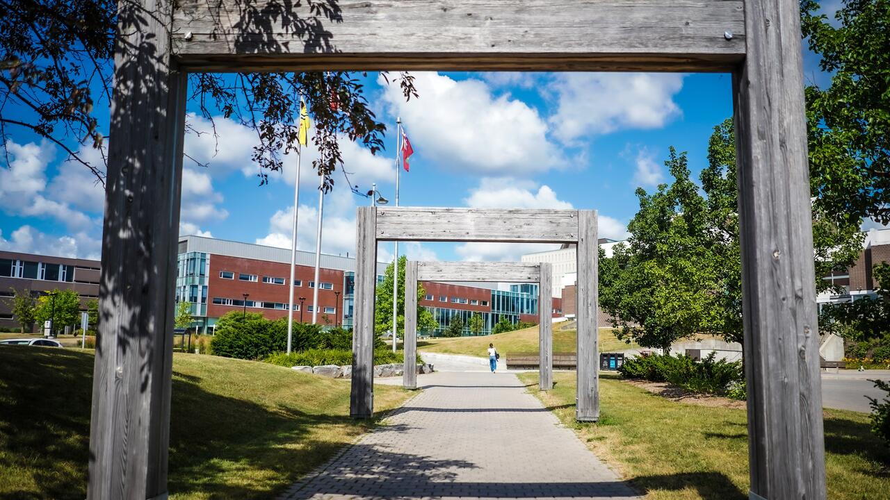 Entrance with wooden arches to campus towards Tatham Centre