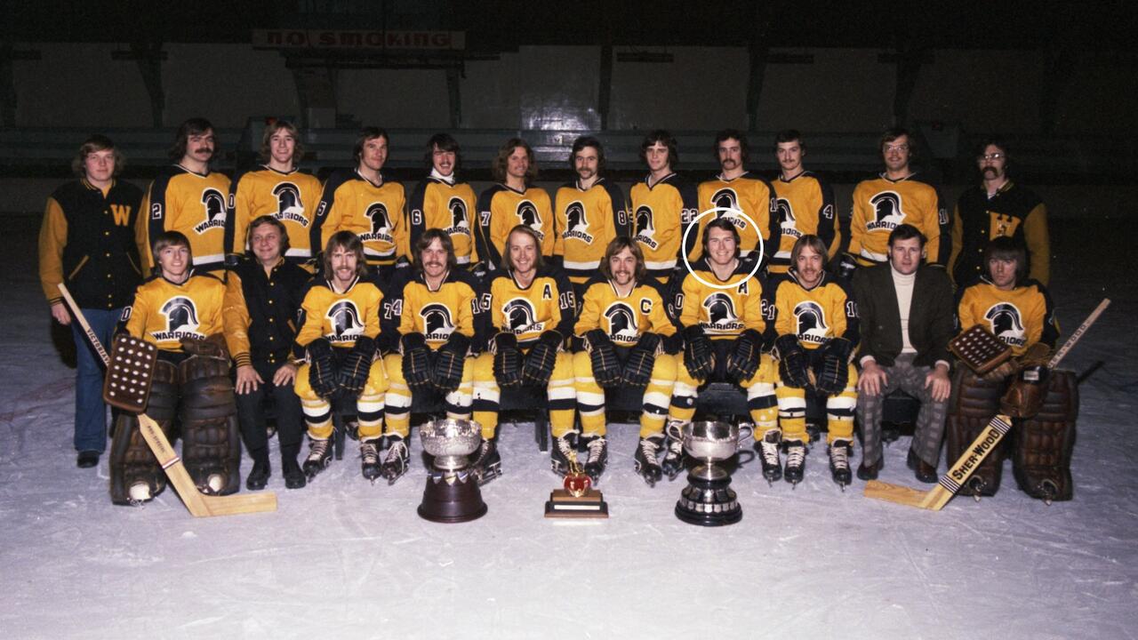 Waterloo Warriors hockey players in uniform pose with three trophies