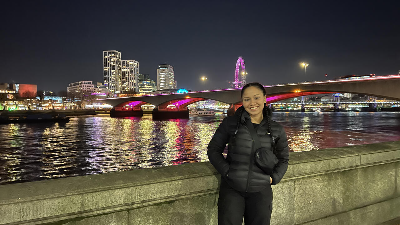 Tharindya Abeyratne poses in front of London Bridge in England