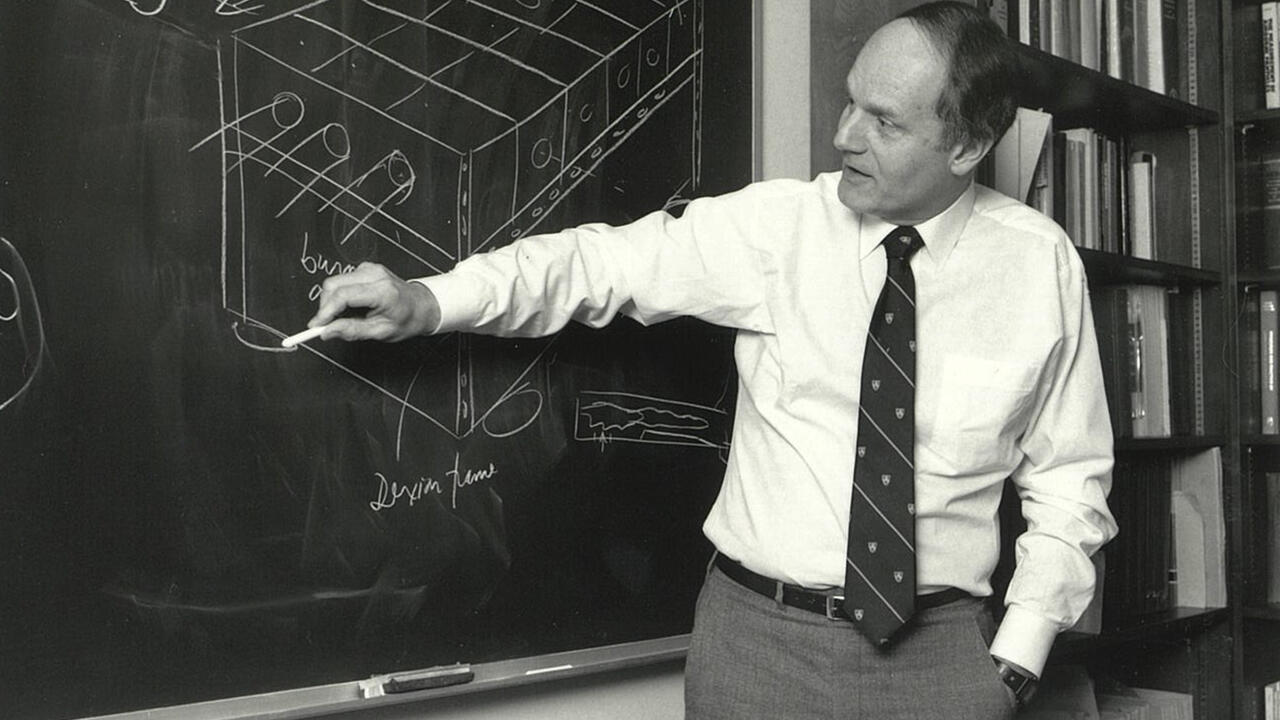 Thomas Bzrustowski lecturing in front of a blackboard