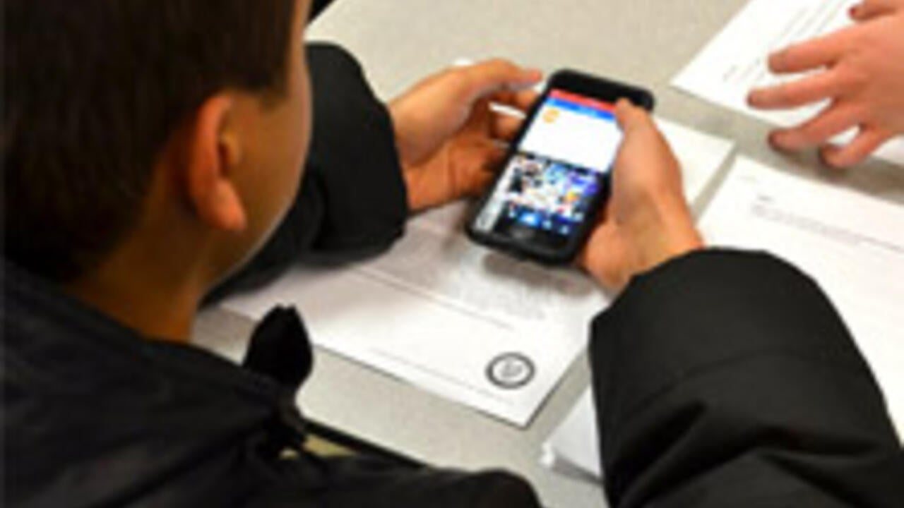 Student participating in user testing on a smartphone