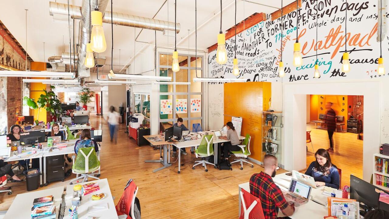 Photo of the Wattpad studio office with employees on their laptops 